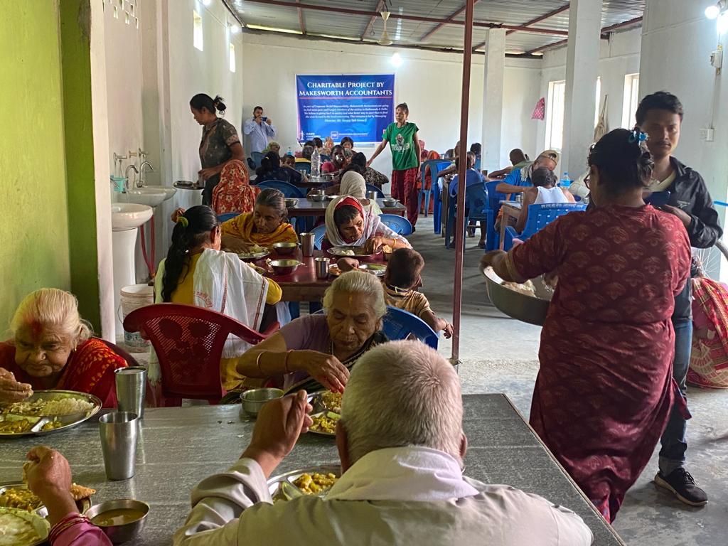 Feeding a group of elderly and disabled people in Padma Bhuwaneshwori Namuna Briddha Sewa Ashram.