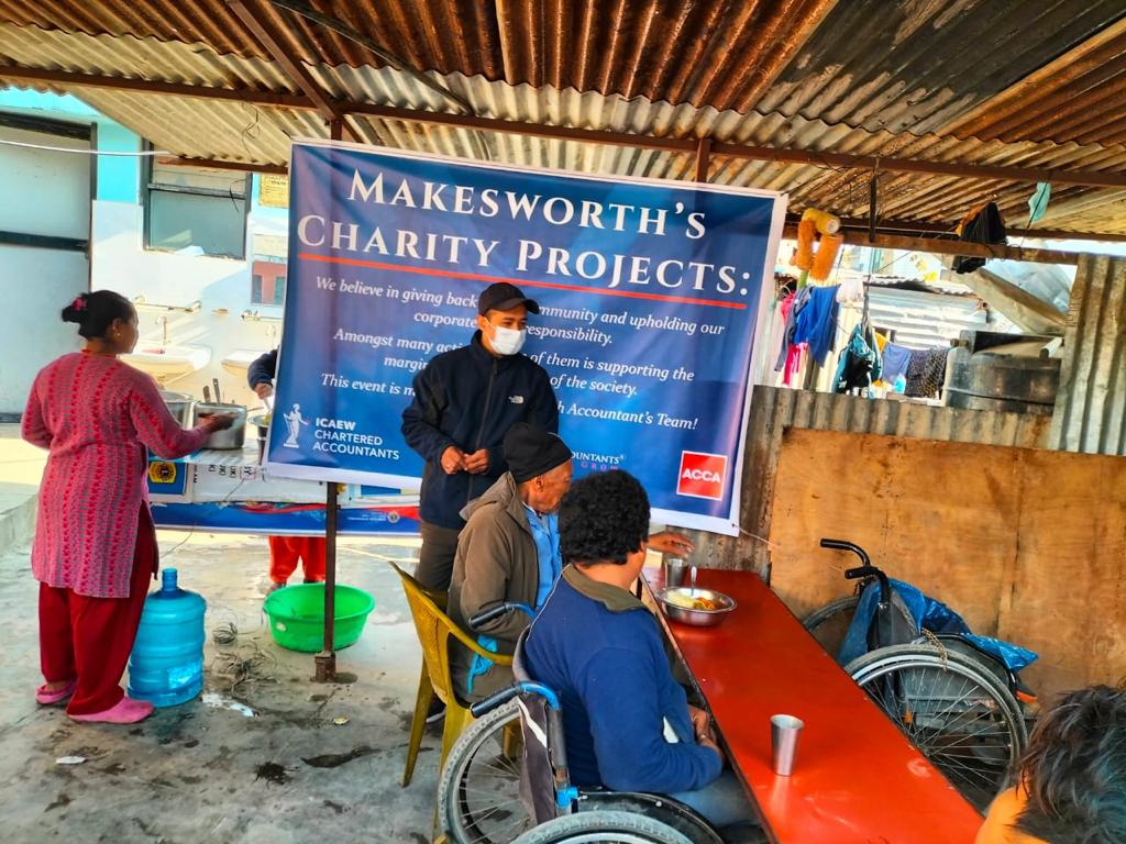 Feeding a group of disabled individuals of the Apanga Sarokar Kendra, Kathmandu today.